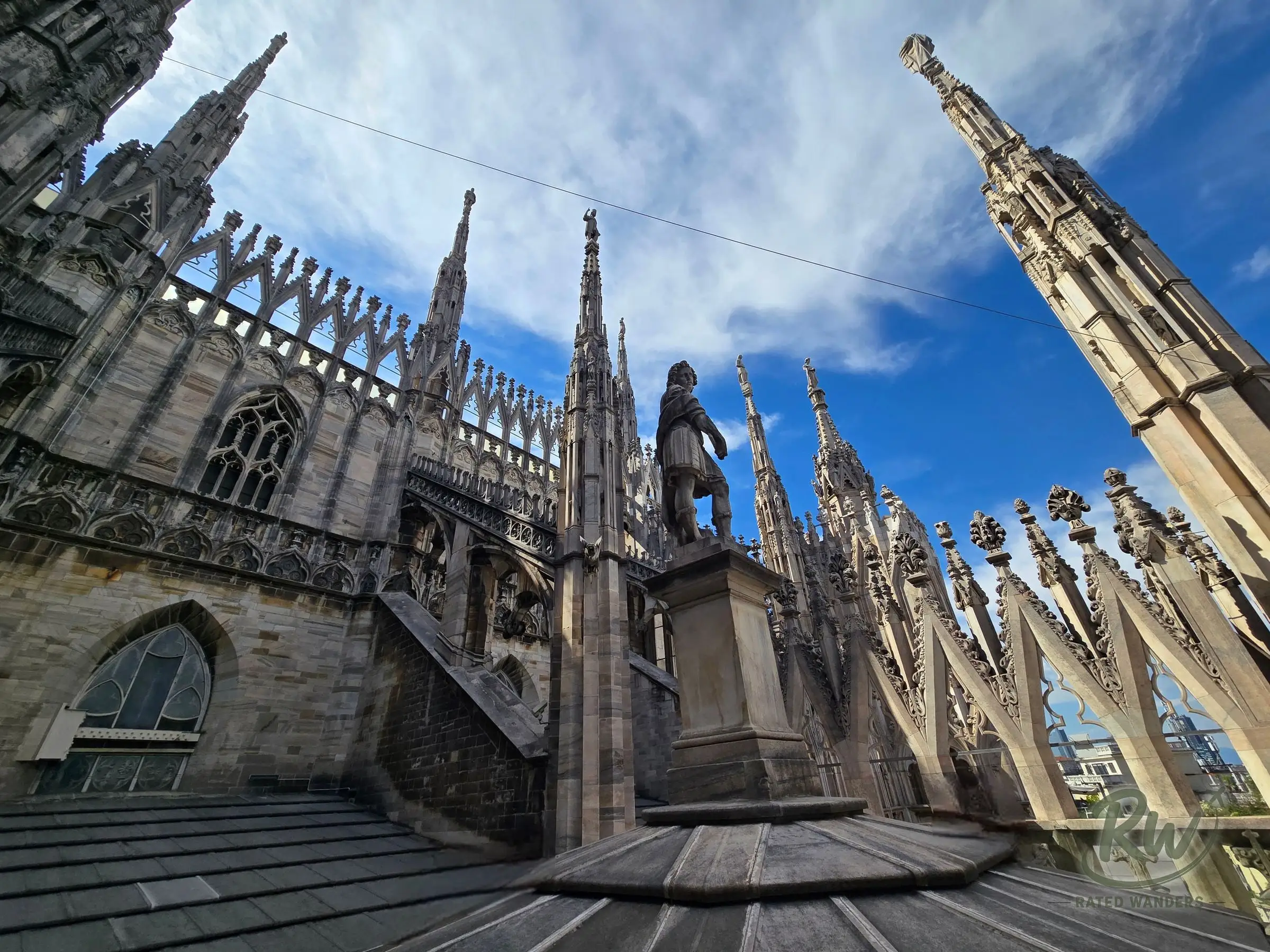 The Duomo’s marble rooftop, with flying buttresses, spires and a statue on a pedestal