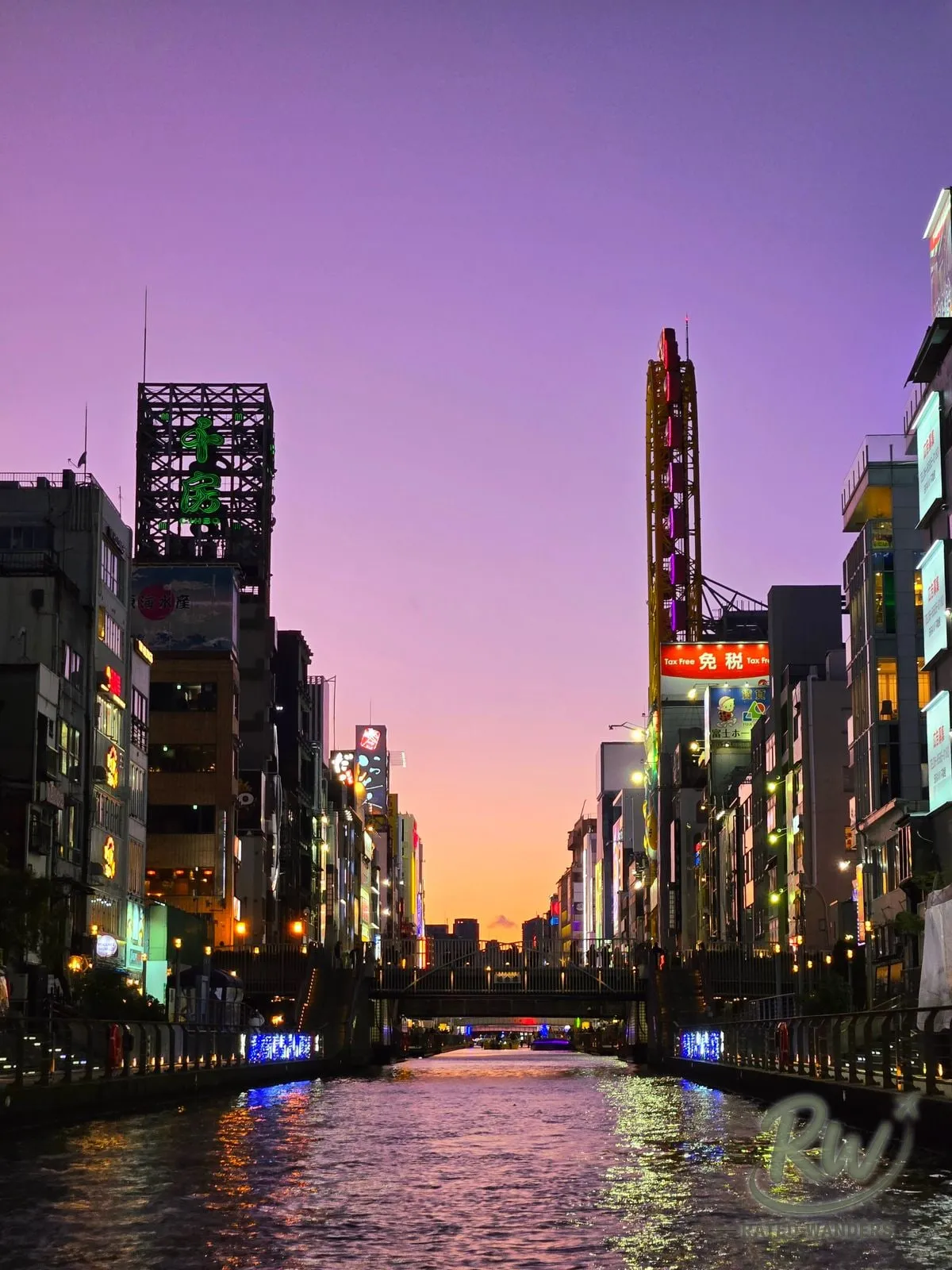 The Dotonbori canal at sunset, neon signs lit under a purple and orange sky