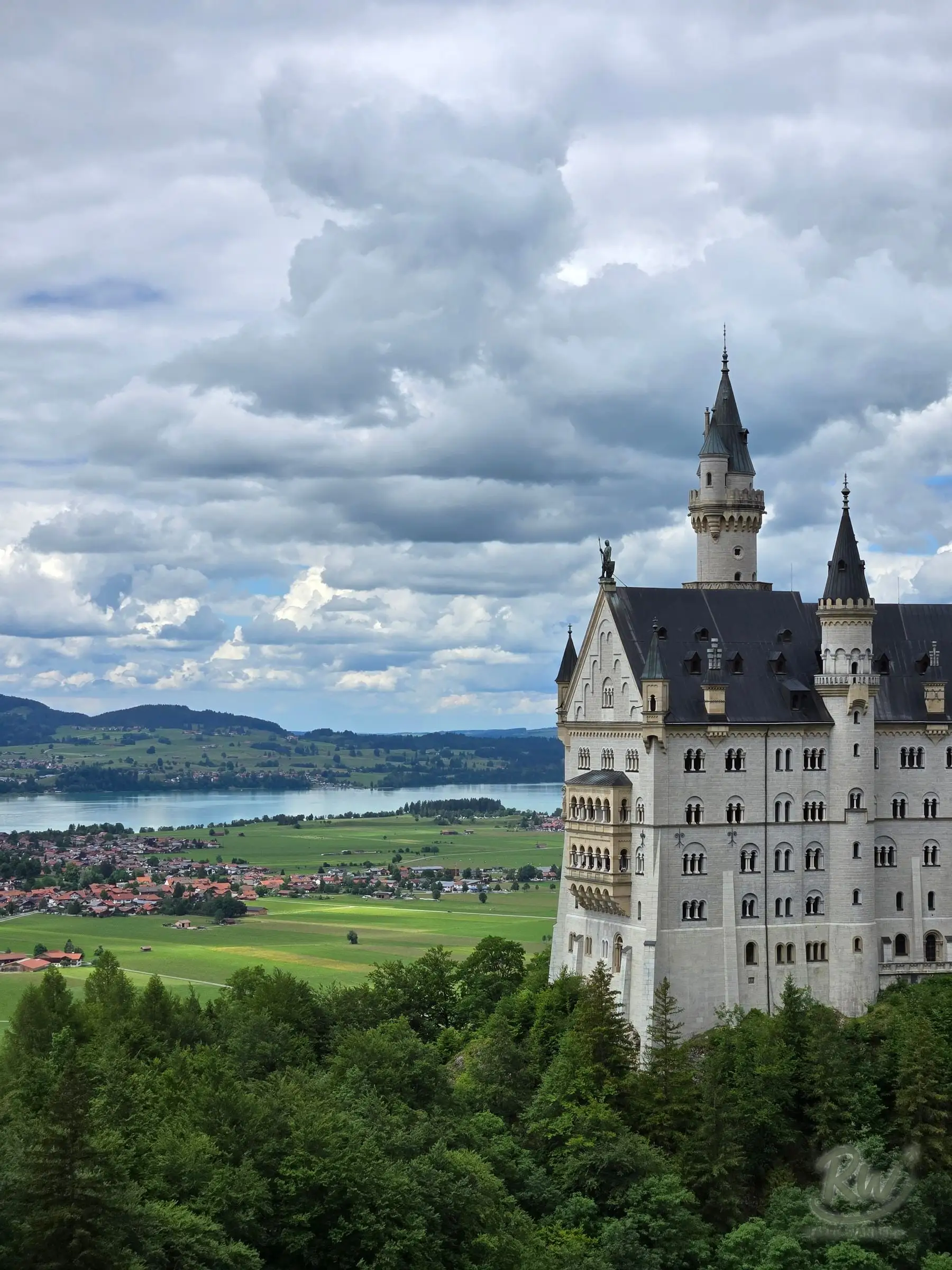 Neuschwanstein Castle from Mary’s Bridge, with the Forggensee and farmland spread out behind it