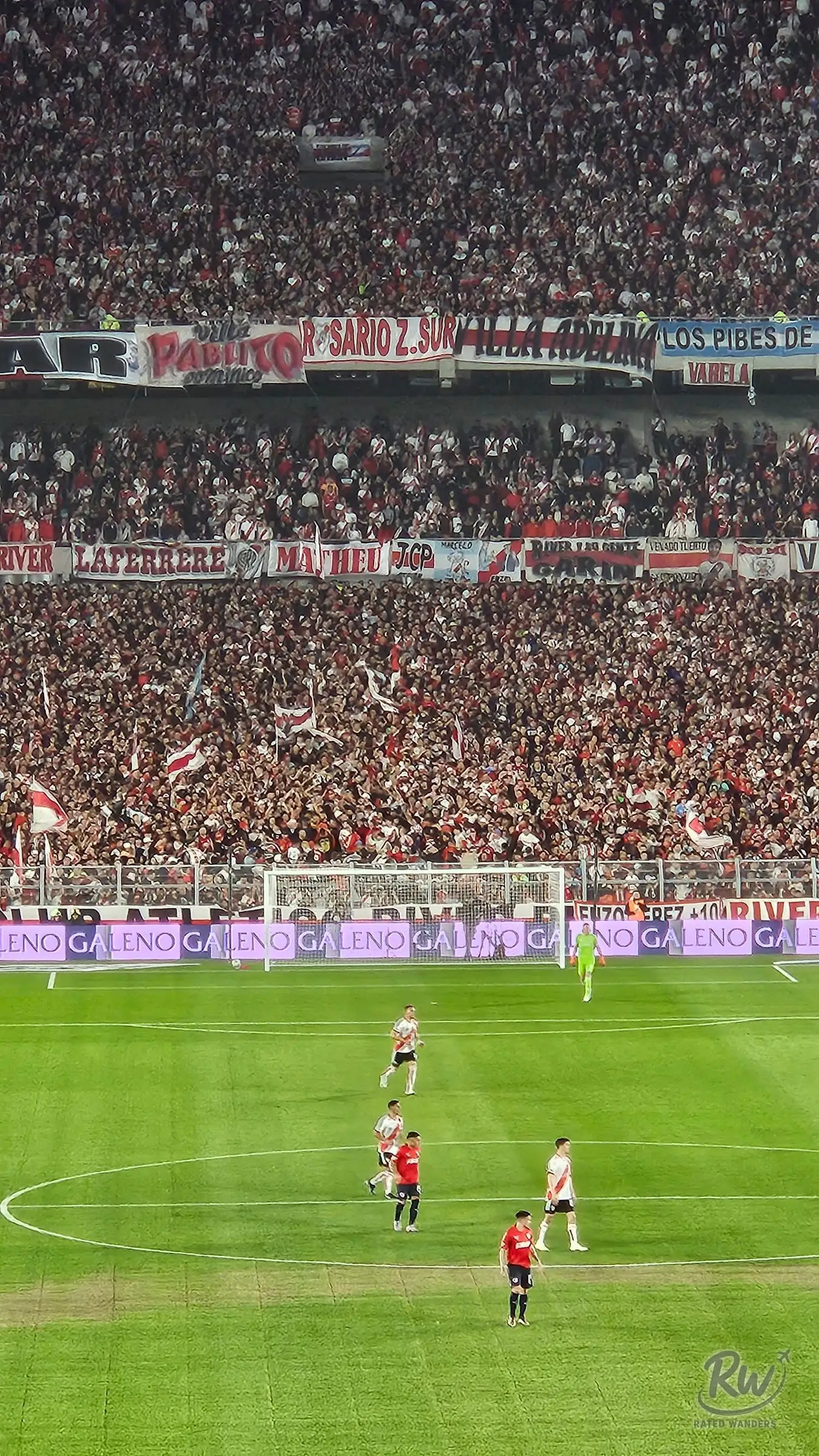 Banners and a packed home end behind the goal as play continues on the pitch