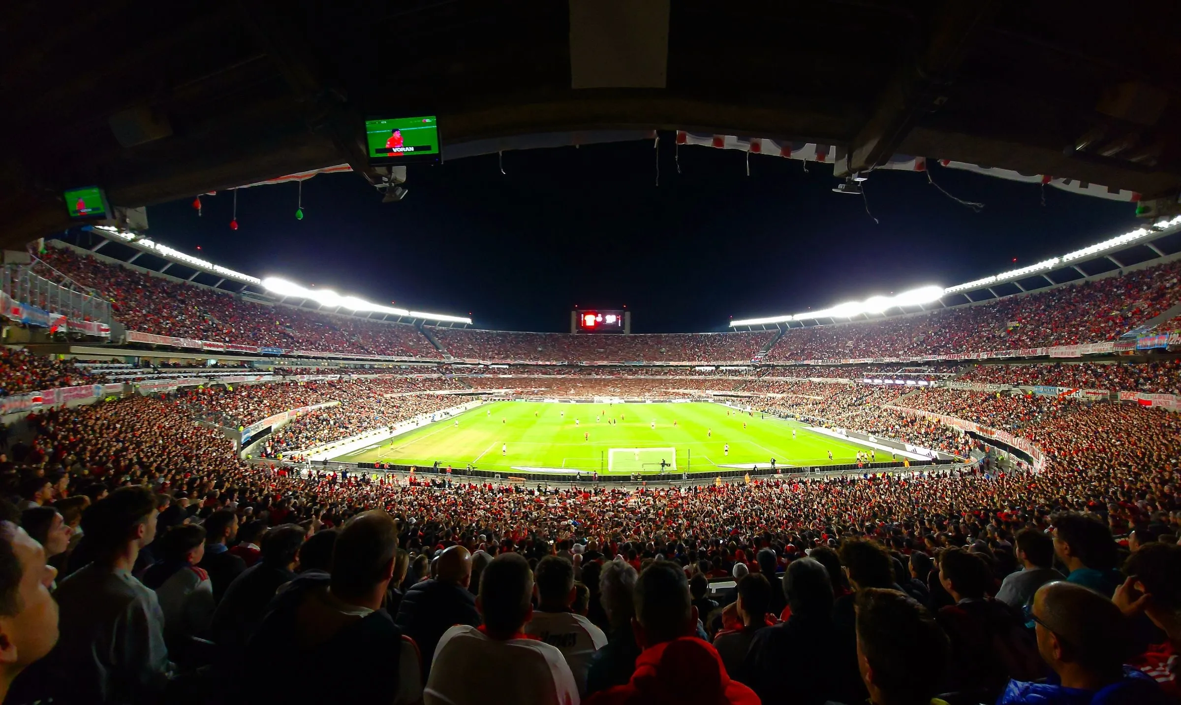 The packed stands of the Estadio Monumental behind the pitch during a River Plate match